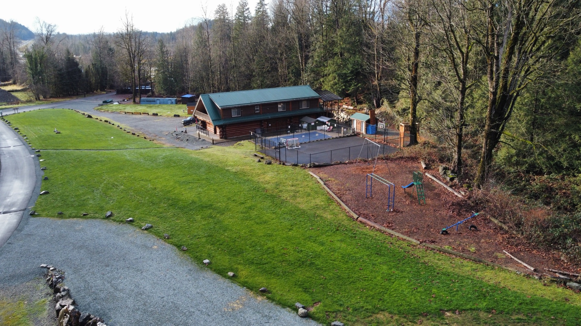 The basketball court and playground on the grounds
