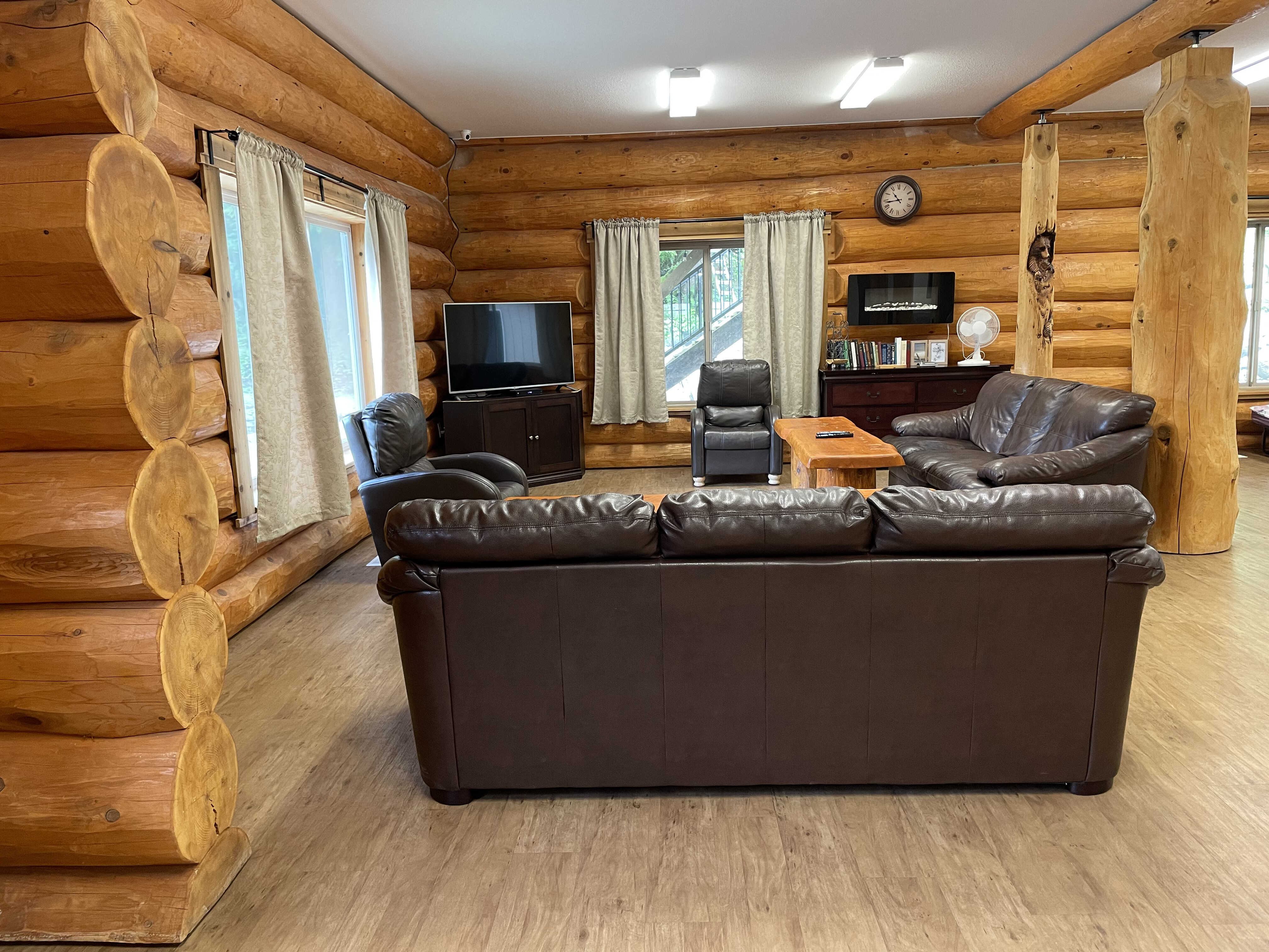 The log-walled main floor lounge with deep leather sofas