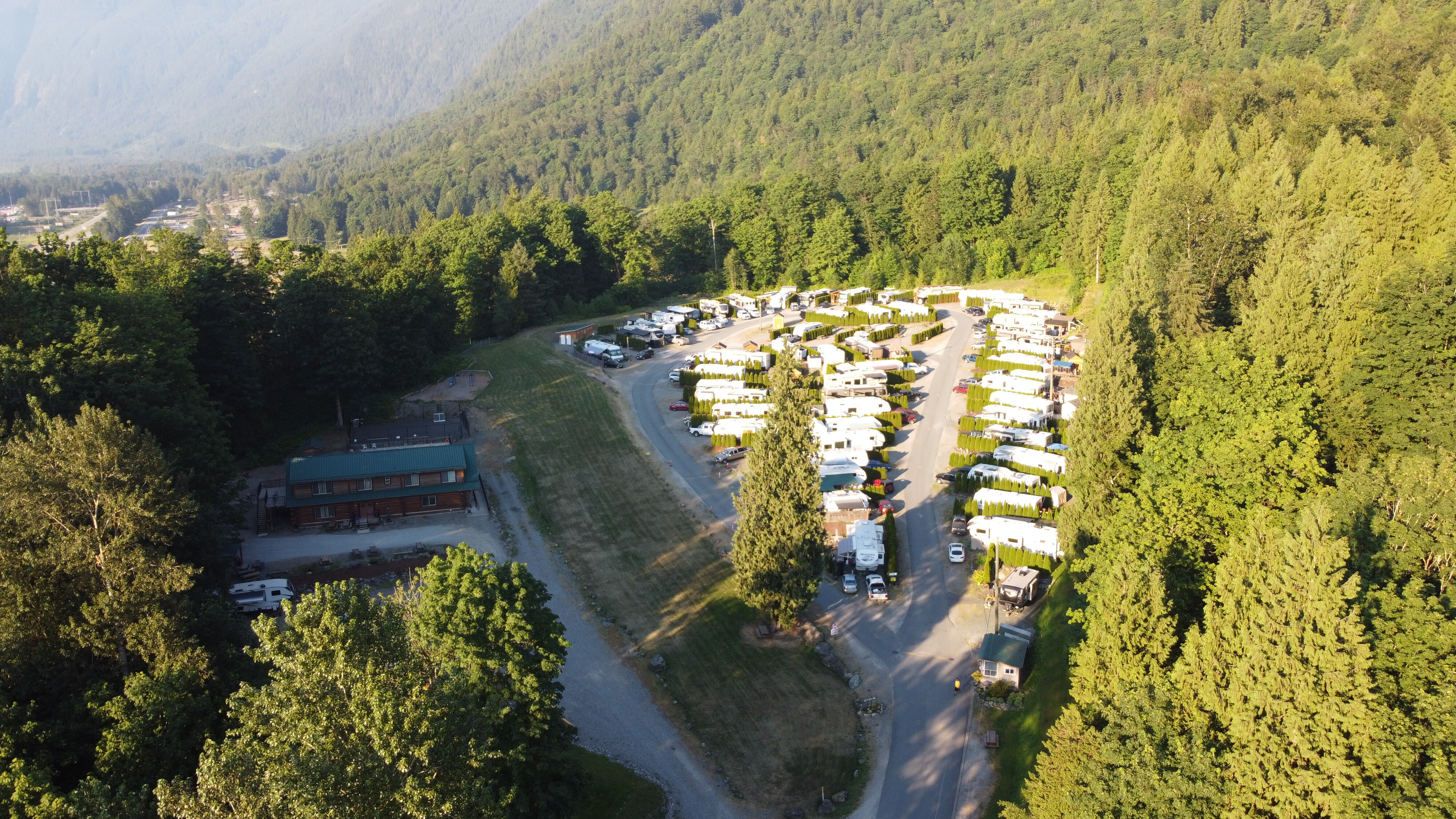 Evening sun over Camp Bridal: RV sites and the lodge tucked into forest beneath Mt. Cheam